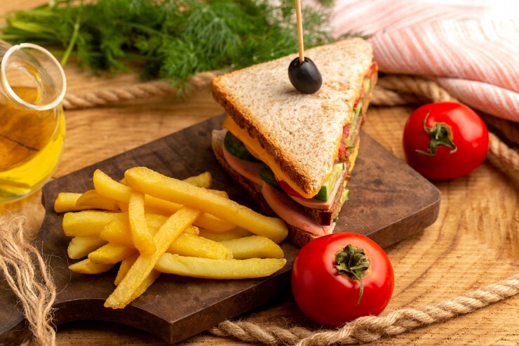 front-close-view-tasty-sandwich-with-olive-ham-tomatoes-along-with-french-fries_140725-20008